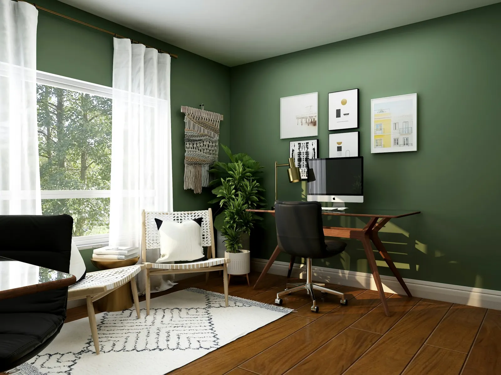 Home office with a green wall, a timber desk and framed artwork